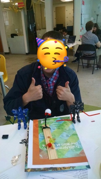 A photo of a boy making a paper prototype