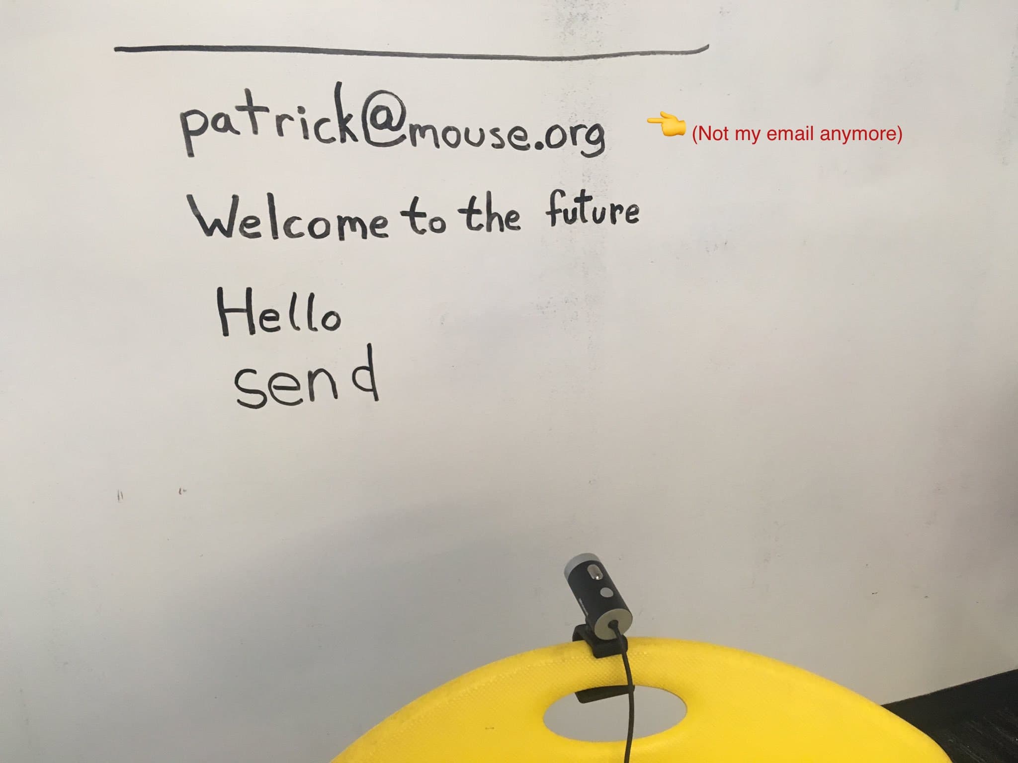 A photograph of email text written on a white board.